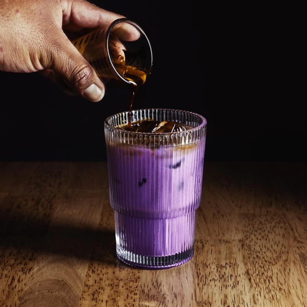 Espresso pouring into a purple specialty drink, sample photograph