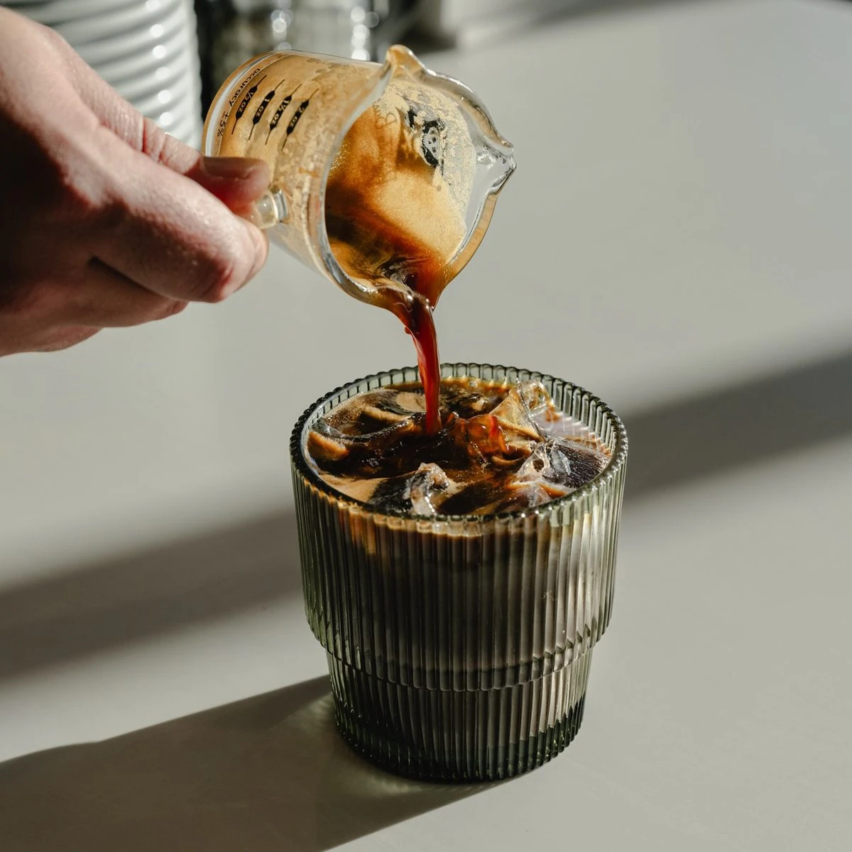 Espresso pouring over an iced drink, sample photograph